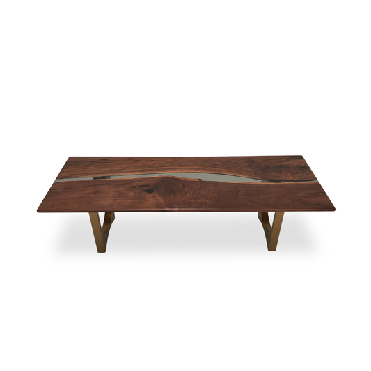 Luxury walnut dining table with gold metal arch pedestal.