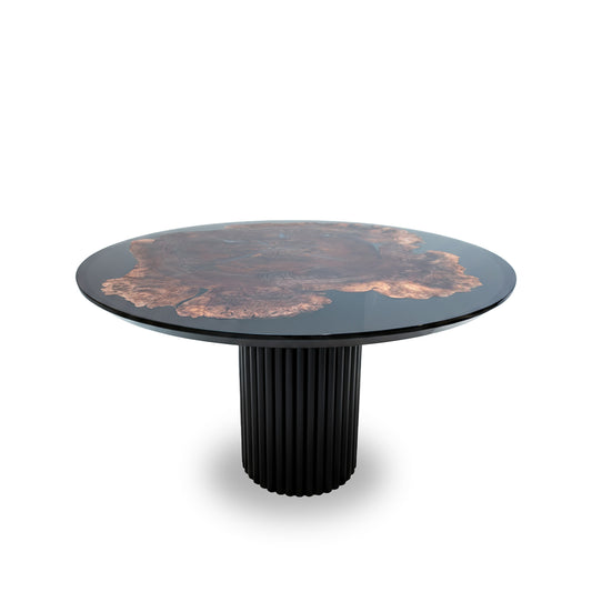 Round table with decorative top and black cylindrical base on a white background